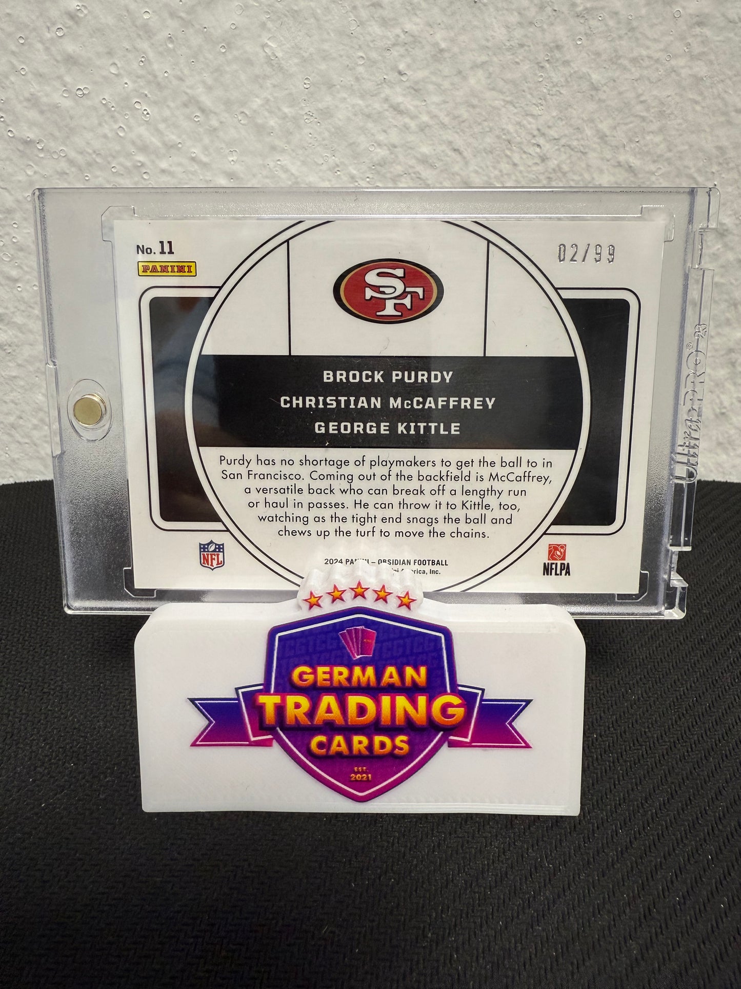 Brock Purdy / Christian McCaffrey / George Kittle Nucleus 02/99 - 2024 Panini Obsidian Football